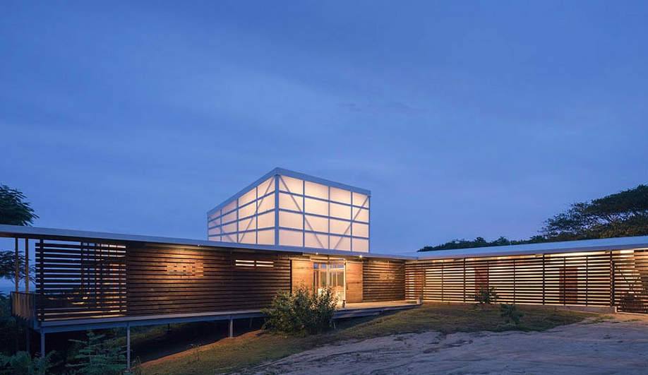 Vancouver style beach house lit up at dusk with clear sky